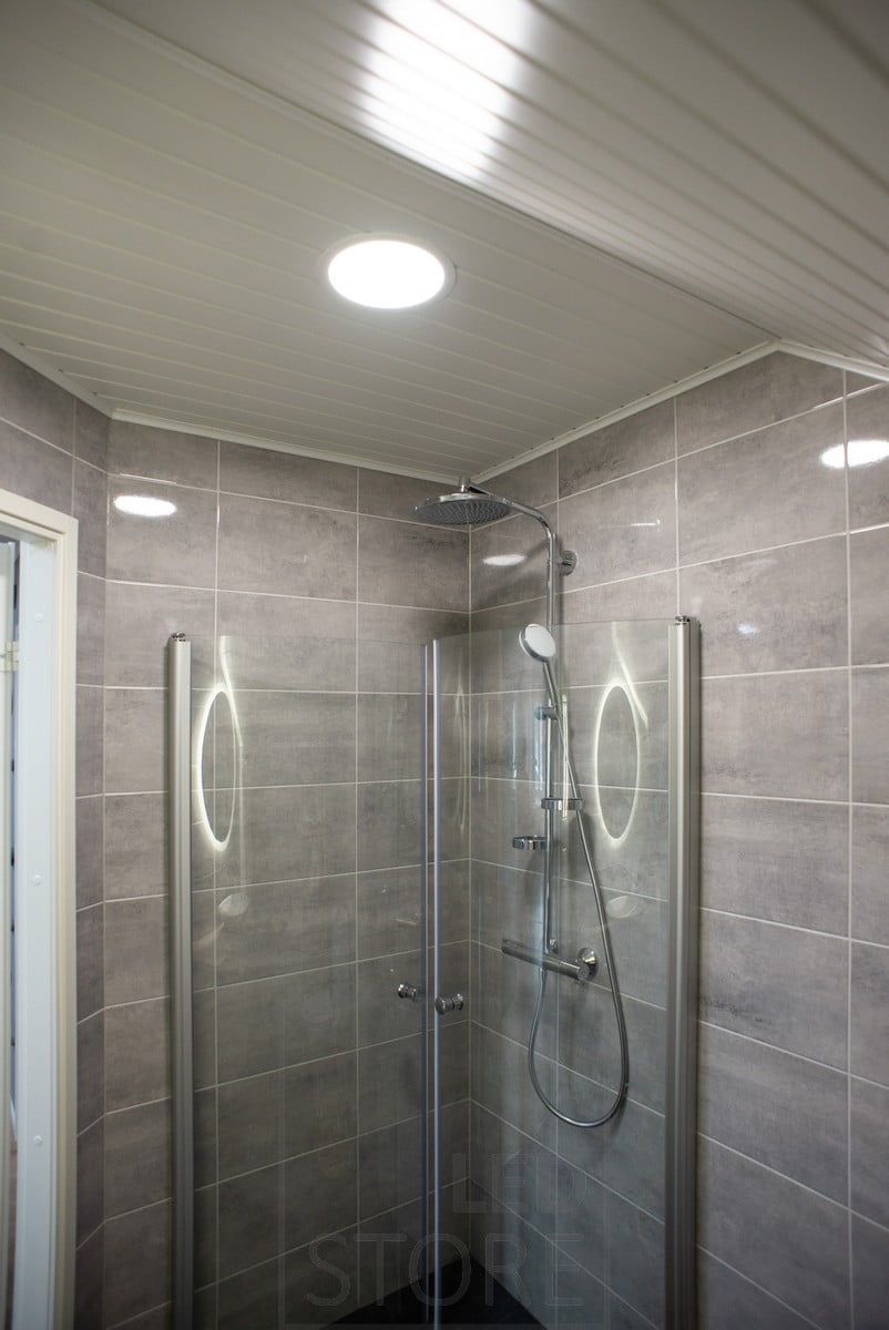 UPPOAVA ceiling tiles illuminating the shower and washroom. The ceiling is IP54 moisture-proof. Ledstore.fi